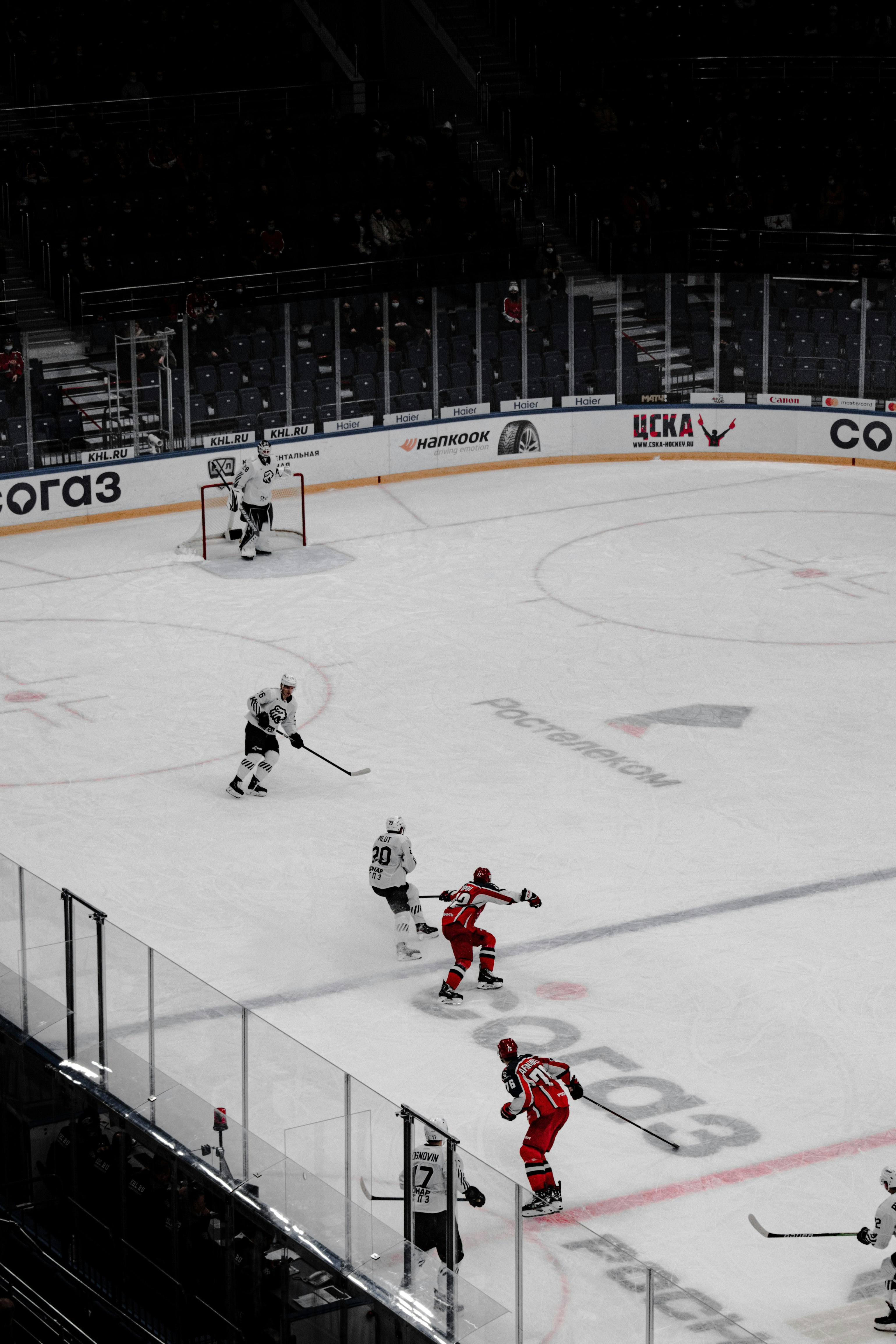 people playing ice hockey on ice stadium